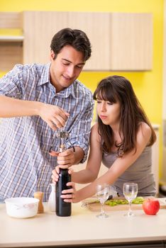 Young couple celebrating wedding anniversary at kitchen 