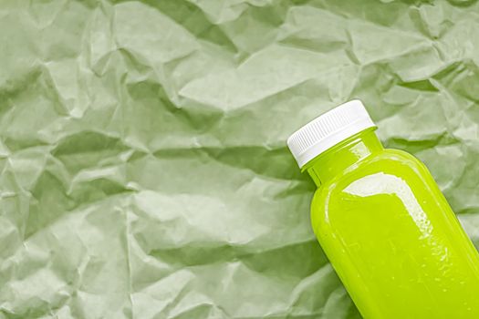 Fresh green juice in eco-friendly recyclable plastic bottle and packaging, healthy drink and food product concept