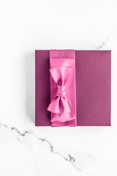 Birthday, wedding and girly branding concept - Pink gift box with silk bow on marble background, girl baby shower present and glamour fashion gift for luxury beauty brand, holiday flatlay art design