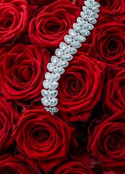 Gemstone jewellery, wedding fashion and luxe shopping concept - Luxury diamond bracelet and bouquet of red roses, jewelry love gift on Valentines Day and romantic holidays present