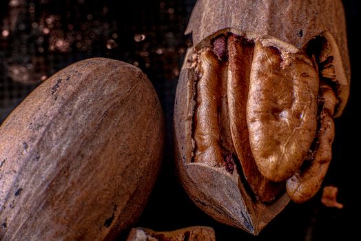 Dried pecan nuts and pecan nut's shells on a wooden table, close up, macro photography. High quality photo