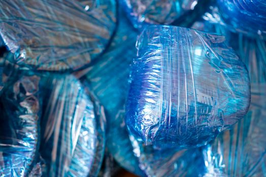 Glassware wrapped with blue wrapping nylon at the bottom of a cardboard box. High quality photo