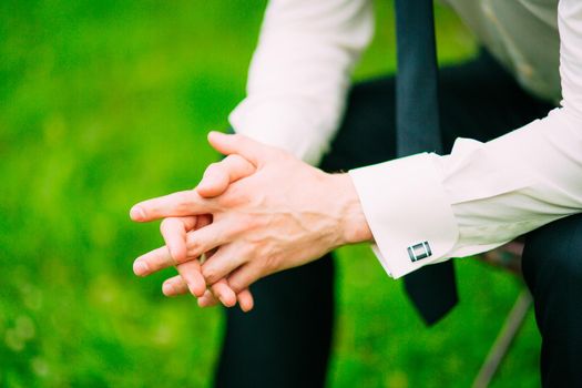 Man's hands. He crossed his fingers. Wedding in Montenegro.