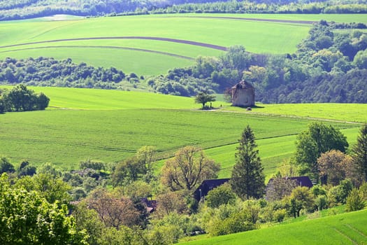 Beautiful spring landscape with blue sky, sun, clouds and old windmill.
Czech Republic Europe