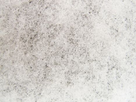 Background of fresh snow. Natural winter background. Snow texture in gray tone