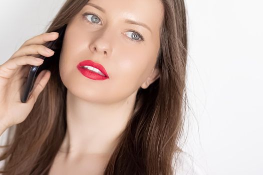 Happy smiling woman calling on smartphone, portrait on white background. People, technology and communication concept.