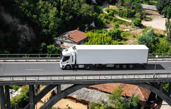 a white truck on the viaduct