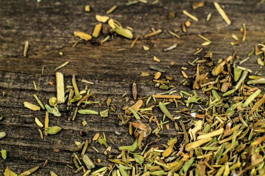 Dried thyme spilled on gray wooden board