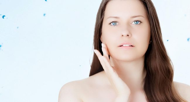 Rejuvenation skincare and beauty ad, beauty face portrait of young woman with healthy clean skin, blue cosmetic liquid drops on background.