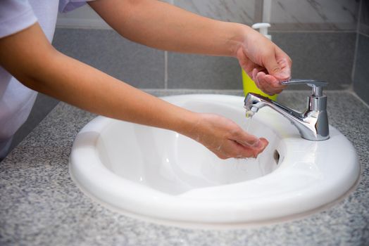 Woman wash hand cleaning with soap in the sink, Disinfection to stop the coronavirus or prevent the spread of the Covid 19 outbreak, Good hygiene protect and be safe from the virus corona