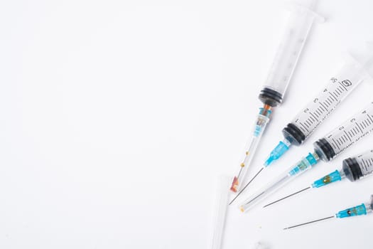 Dirty used plastic syringes, isolated with copy space