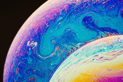 Fluid art made of colorful soap bubble film. Trendy Inkscape blurred background. Alien space planets art. Selective focus.