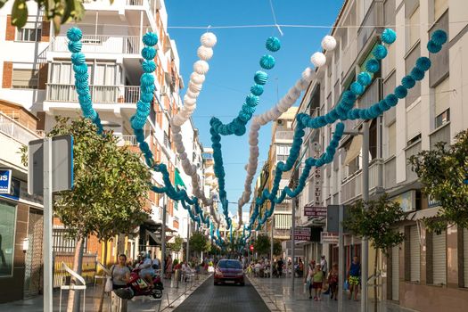 Torre del Mar, Spain - July 29, 2018. Tourists on the most beautiful street in Torre del Mar, Princesa street, Malaga region, Spain