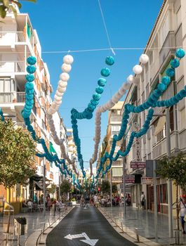 Torre del Mar, Spain - July 29, 2018. Tourists on the most beautiful street in Torre del Mar, Princesa street, Malaga region, Spain