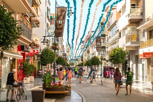 Torre del Mar, Spain - July 29, 2018. Tourists on the most beautiful street in Torre del Mar, Princesa street, Malaga region, Spain