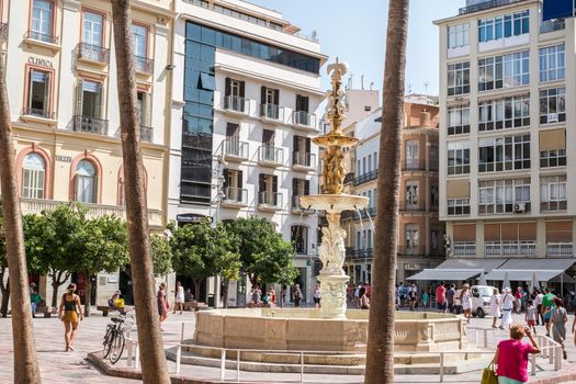 Malaga, Spain - August 04, 2018. iew of Main Square (Plaza de la Constitucion) in Malaga city, Andalusia, Spain. It's a popular shopping destination for tourists and locals