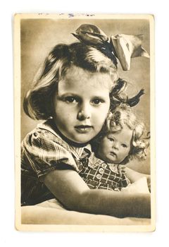 Sibiu City, Romania - 31 May 2020. Vintage postcard shows a little girl with a doll in her arms, circa 1950