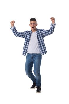 Full length portrait of a young man with arms raised isolated on a white background