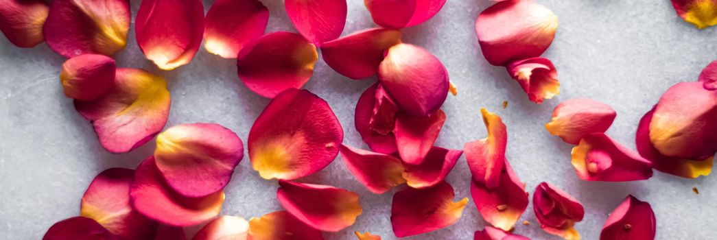 Rose petals on marble background, floral decor and wedding flatlay, holiday greeting card backdrop for event invitation, flat lay design.