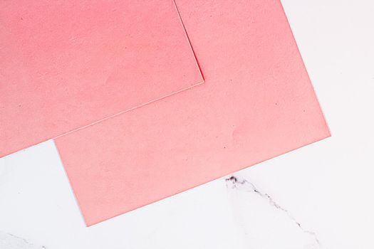 Pink A4 papers on white marble background as office stationery flatlay, luxury branding flat lay and brand identity design for mockups