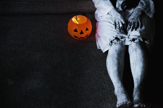 Woman ghost horror her have pumpkin beside body, halloween concept