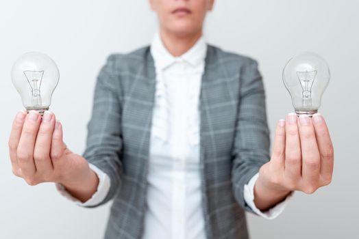 Lady Carrying Two Lightbulbs In Hands With Formal Outfit Presenting Another Ideas For Project, Business Woman Holding 2 Lamps Showing Late Technologies, Lighbulbexhibiting Fresh Openion.