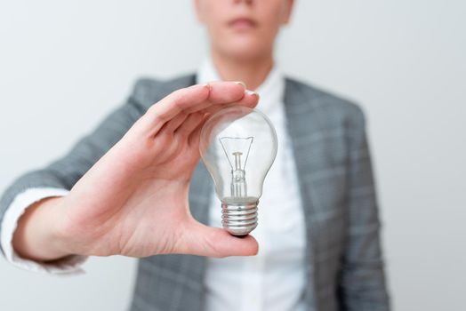 Lady Holding Lamp With Formal Outfit Presenting New Ideas For Project, Business Woman Showing Bulb With One Hand Exhibiting New Technologies, Lightbulb Presenting Another Openion.