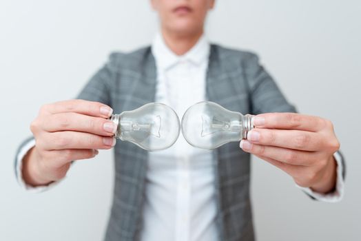 Lady Holding Two Lamps Upside Down With Outfit Proposing New Ideas For Project, Business Woman Carry 2 Bulbs Opposite Displaying New Technologies, Two Vise Versa Lamps Exhibiting Fresh Idea.