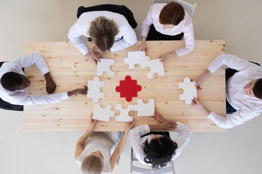 Business people team and jigsaw puzzle pieces teamwork cooperation unity problem solution concept