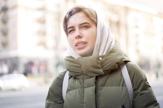 Woman portrait confidence brunette dressed warm winter jacket city street background dramatic atmosphere Caucasian female headshoot smoking cigarette Real life Women's parka