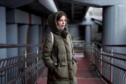 Woman portrait confidence brunette dressed warm winter jacket dark background dramatic atmosphere Caucasian female headshoot Women's parka