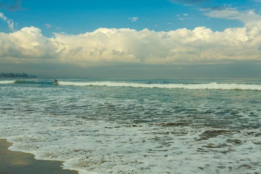 surfers in famous Kuta beach in Bali Indonesia