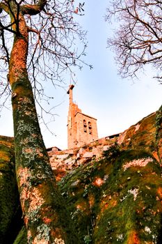 Beautiful sunset in leafy forest with colossal rock formations and majestic trees with soft sun rays in the Sanctuary of Penha in Guimaraes, Portugal