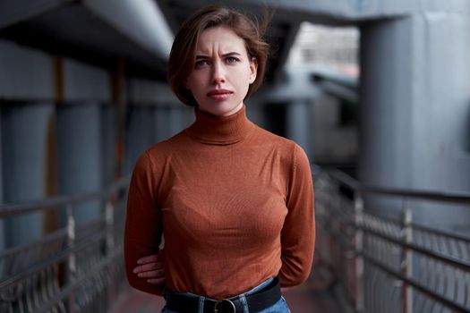 Woman portrait confidence brunette dressed brown turtleneck dark background dramatic atmosphere Caucasian female headshoot Women's golf sweater style