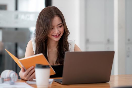 Photo of joyful attractive woman using laptop for online conference, Business female working at home.