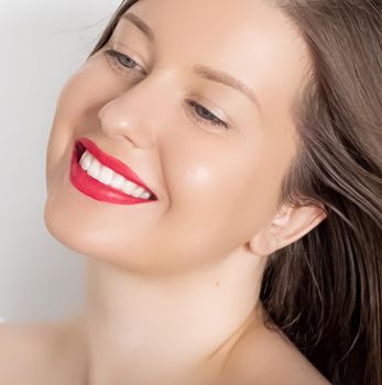 Happy smiling young woman with perfect white teeth and beautiful healthy smile, clean skin and natural makeup, female face portrait with positive emotion, beauty, wellness and skincare ad.