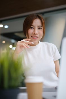 Portrait of Asian business woman smiling and relaxing in casual