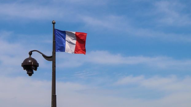 A French flag on a lamppost in Paris France. April 2019