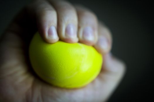 Exercises with one hand and yellow physiotherapy ball