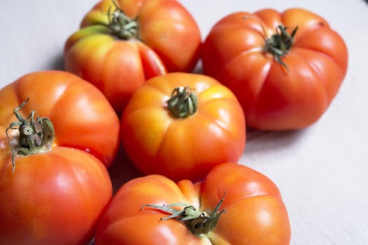 Group of uncooked raw red tomatoes. Raw food