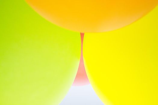 Balloons of colors grouped, green, pink, yellow, orange, pink. No people