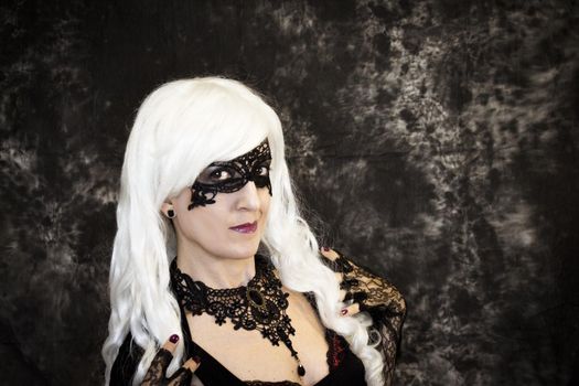 Woman disguised in gothic style for halloween party with mask