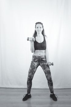 Woman over 40 years old exercising with weights. Strong woman