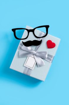 Father's day background design concept. Top view of color paper decoration layout ideas with gift box on blue table background with copy space.