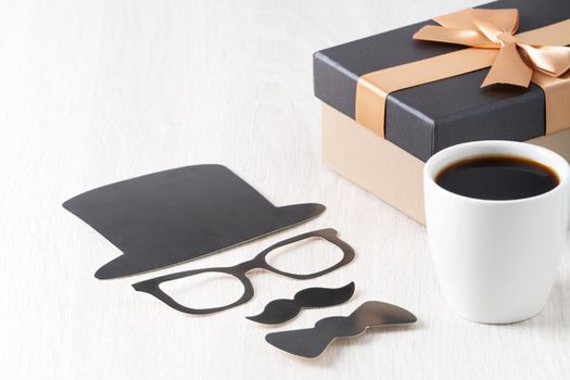 Father's day design concept. Close up of cup of coffee and gift box for daddy funny idea.