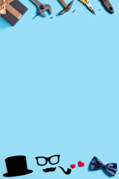Father's day background design concept. Top view of color paper decoration layout ideas and working tool on blue table background with copy space.
