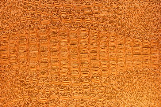 Orange crocodile leather texture. Abstract background for design.