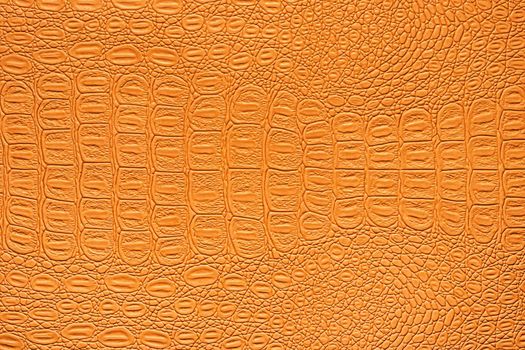 Orange crocodile leather texture. Abstract background for design.