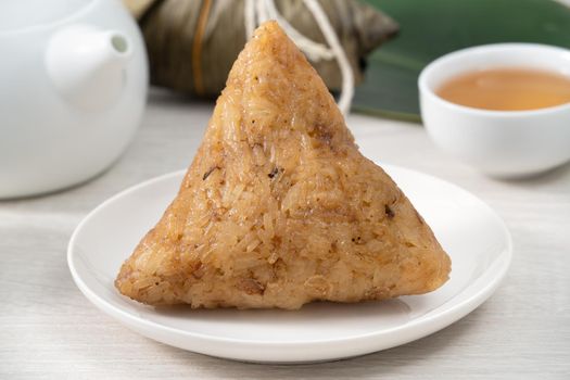 Zongzi. Rice dumpling for Chinese traditional Dragon Boat Festival (Duanwu Festival)  on bright wooden table background.