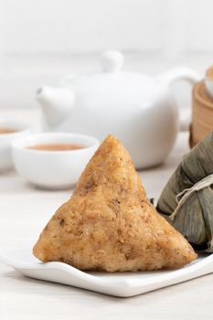 Zongzi. Rice dumpling for Chinese traditional Dragon Boat Festival (Duanwu Festival)  on bright wooden table background.